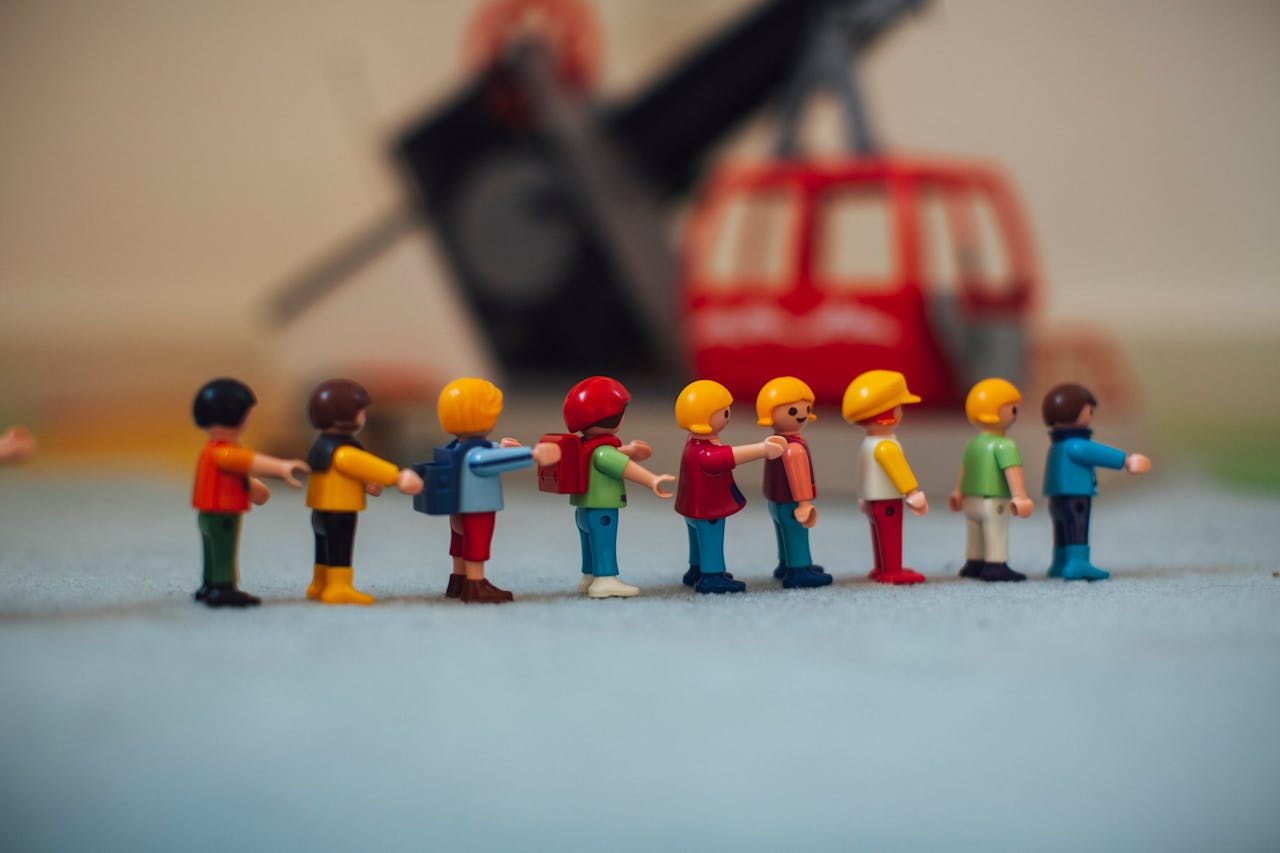 Miniature plastic figures lined up in front of a toy helicopter, creating a playful scene.