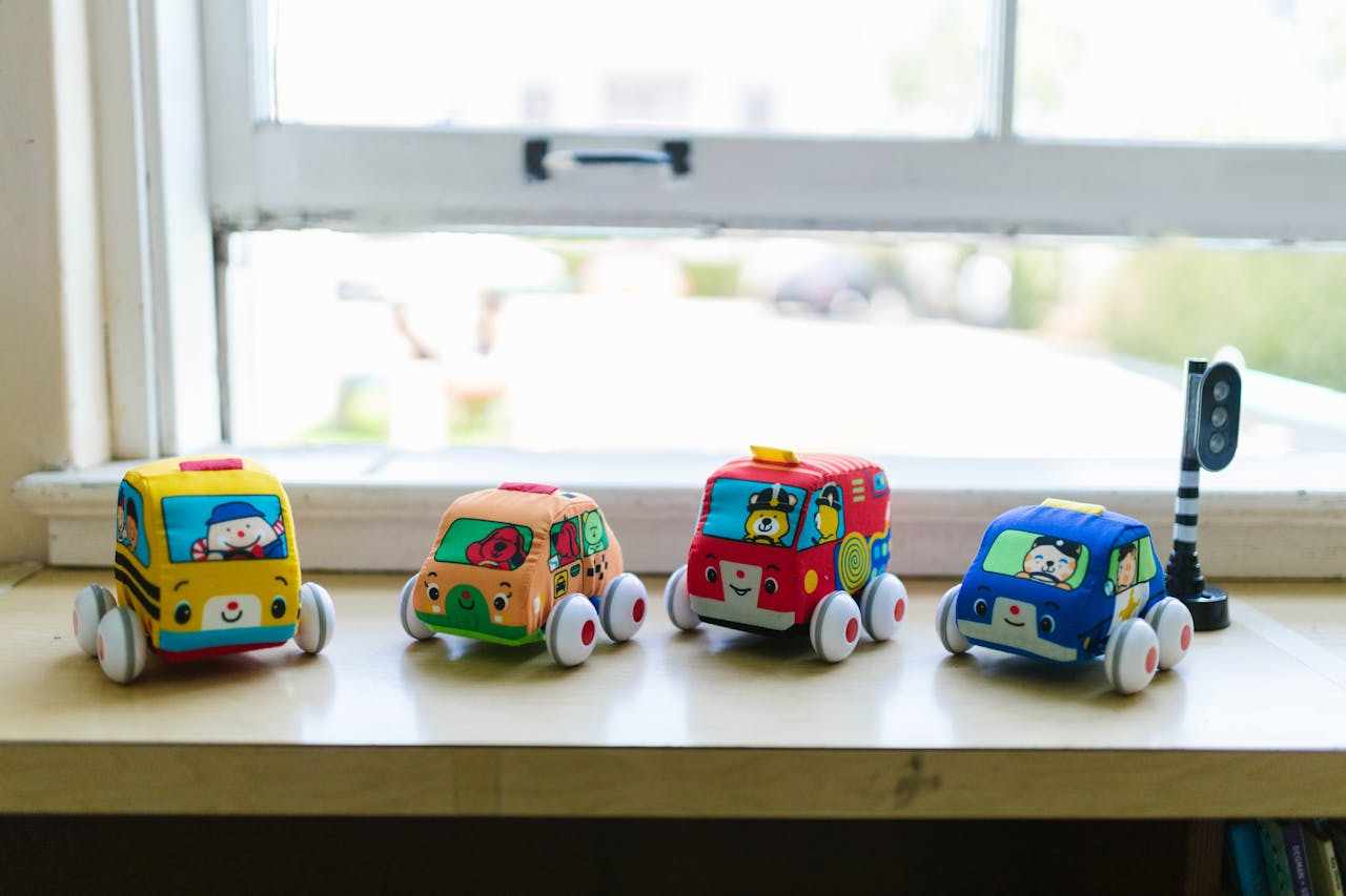 Vibrant toy cars lined up on a windowsill, adding a playful charm to the room.